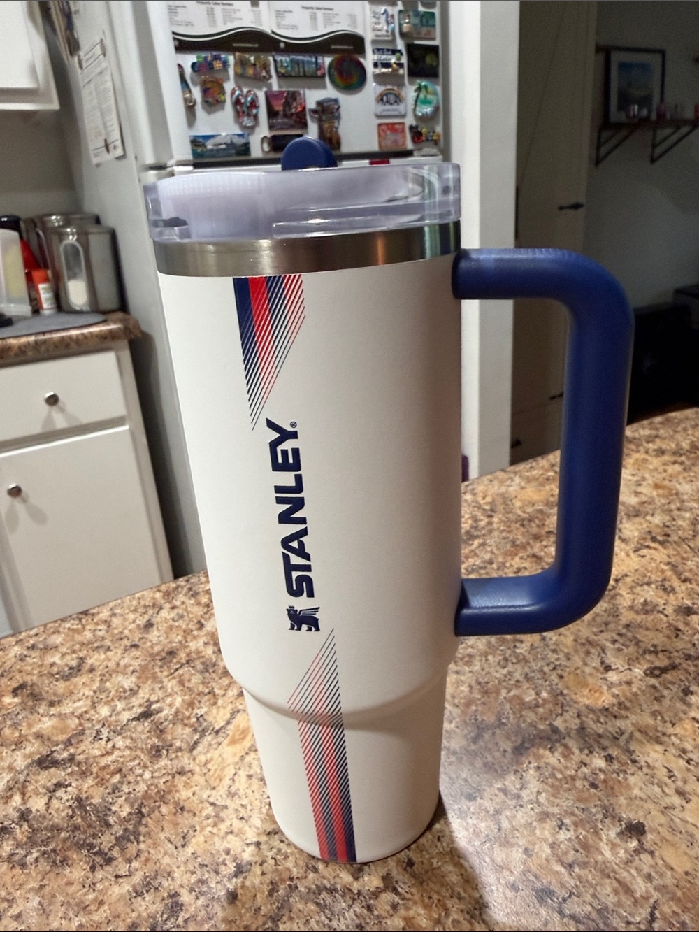 Stanley White Travel Tumbler with Blue Handle and Red Accent